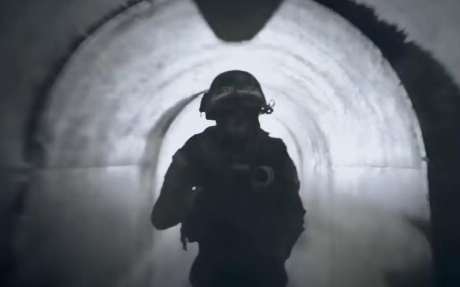 A video screen grab shows a militant navigating through a tunnel in Gaza.