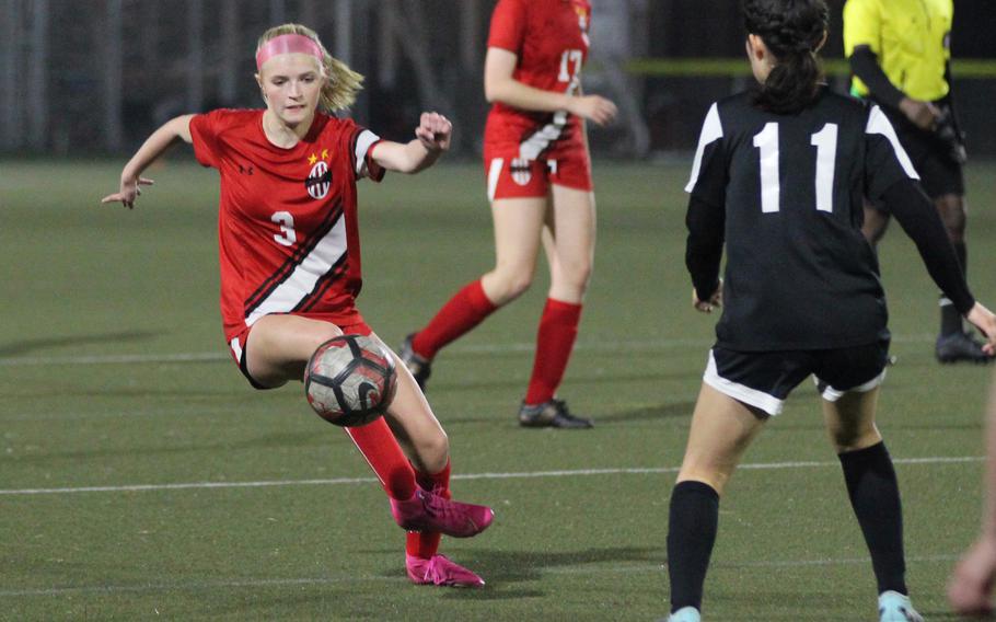 Nile C. Kinnick’s Hailey Witt sends the ball past Zama‘s Lindsey So during Friday’s DODEA-Japan girls soccer match. The Red Devils won 8-0.