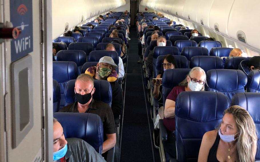 Masked passengers fill a Southwest Airlines flight from Burbank to Las Vegas on June 3, with middle seats left open.