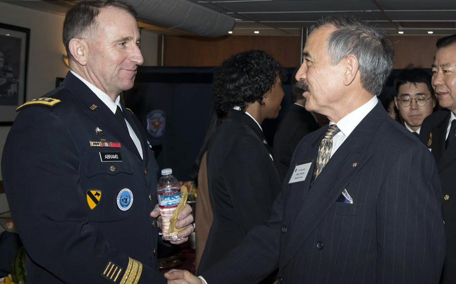 Then-U.S. Forces Korea commander Gen. Robert Abrams, left, greets then-U.S. Ambassador to South Korea Harry Harris aboard the USS Blue Ridge in 2019. 