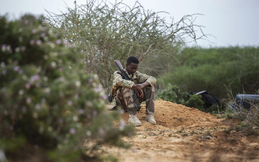 A soldier sits in a military camp in Masjid Ali Guduud. 