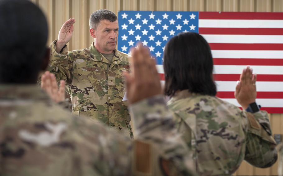 Air Force Brig. Gen. Andrew Clark, 380th Air Expeditionary Wing commander, administers an oath to the Teal Team 6 volunteer members during the sexual assault prevention and response induction ceremony at Al Dhafra Air Base, United Arab Emirates, June 18, 2021. 