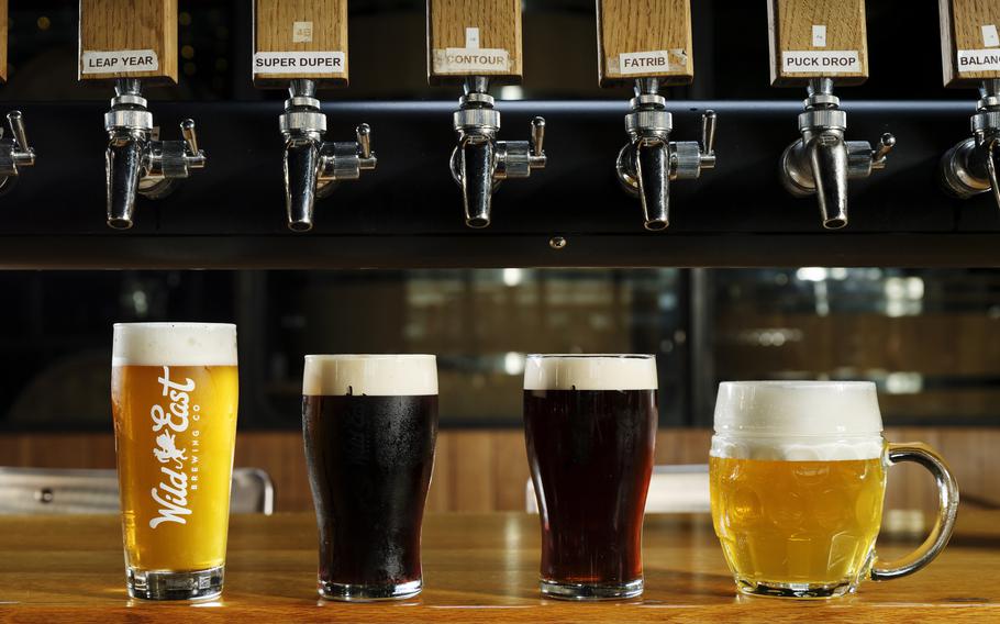 A variety of beer styles are displayed on the bar at Wild East Brewing in Brooklyn. From left: a standard draft pour, a nitrogen pour, a cask pour and a Lukr side-tap hladinka pour. 