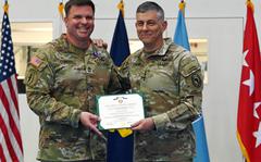 U.S. Africa Command Commander Gen. Stephen J. Townsend and Master Sgt. Steven Corley pose for a photo during a Purple Heart ceremony April 8, 2022, in Stuttgart, Germany. Corley was wounded during an attack while serving as the leader of a six-person team in northwest Africa. 