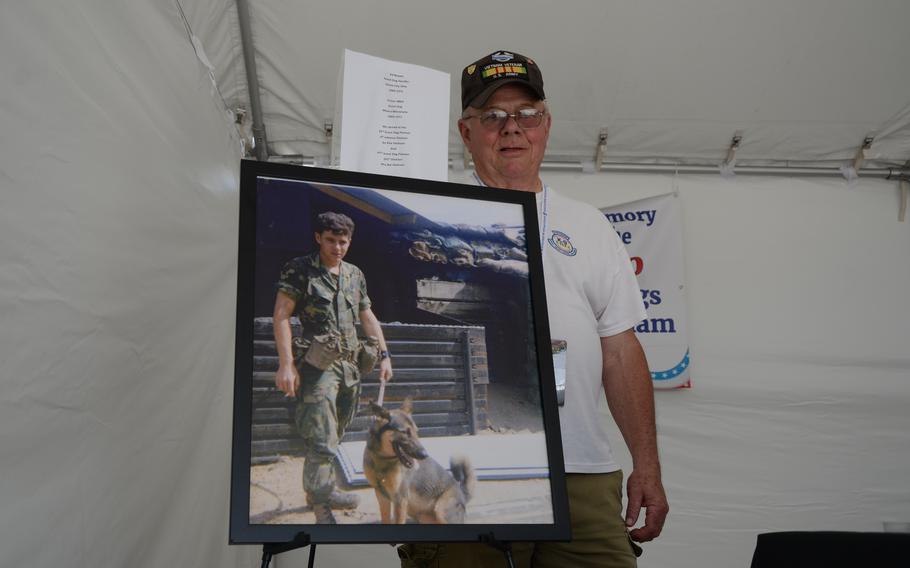 Ed Reeves, a former Army scout dog handler, standing next to a photo from 1971 of him and his dog, Prince. Reeves, 72, was with the Vietnam Dog Handlers Association on May 12, 2023, attending the three-day “Welcome Home” event in Washington, D.C., for Vietnam veterans on the 50th anniversary of the war ending. 