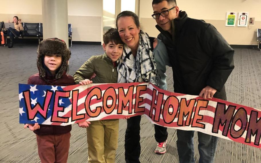 Army Sgt. 1st Class Andrea Hayden reunites with her sons Samuel and Peter and husband, Daichi, on Jan. 30, 2020, after finishing a deployment that saw her survive an Iranian missile barrage.