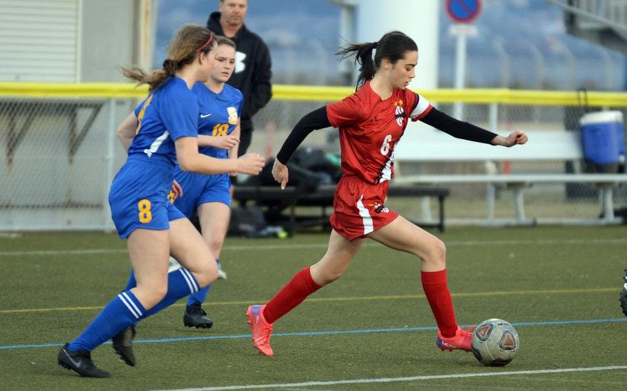 Nile C. Kinnick's Julia Angelinas dribbles the ball ahead of Yokota's Annie Mitchell and Hailey Riddels during Friday's DODEA-Japan soccer match. The teams played to a 1-1 draw.