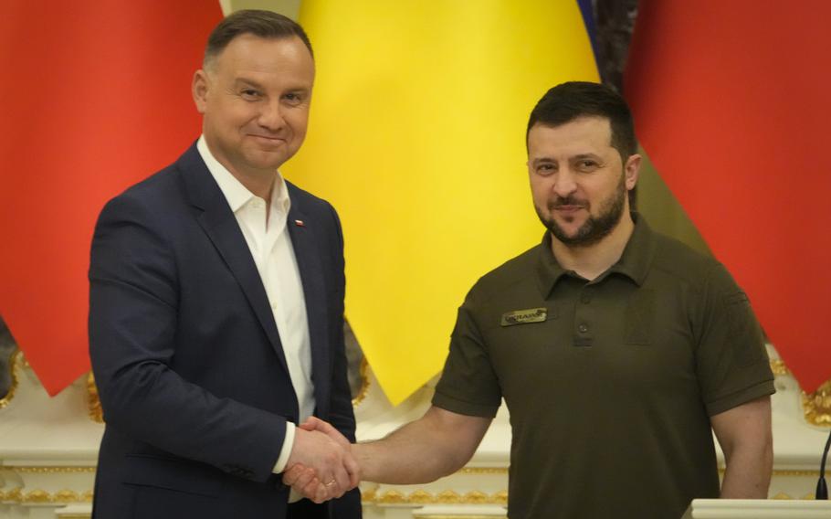 Ukrainian President Volodymyr Zelenskyy, right, and Polish President Andrzej Duda shake hands during a news conference after their meeting in Kyiv, Ukraine, Sunday, May 22, 2022. 