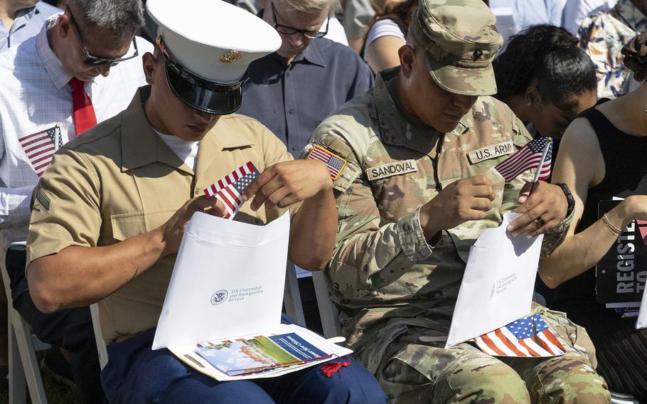 A Marine and Army service members checking their document packages 