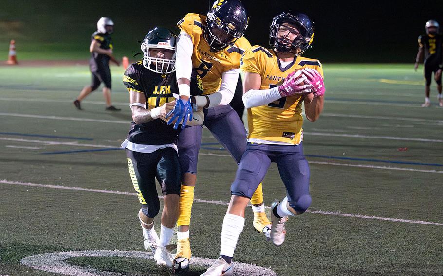 Guam High's Judah Alcantara, right, intercepts a John F. Kennedy pass.