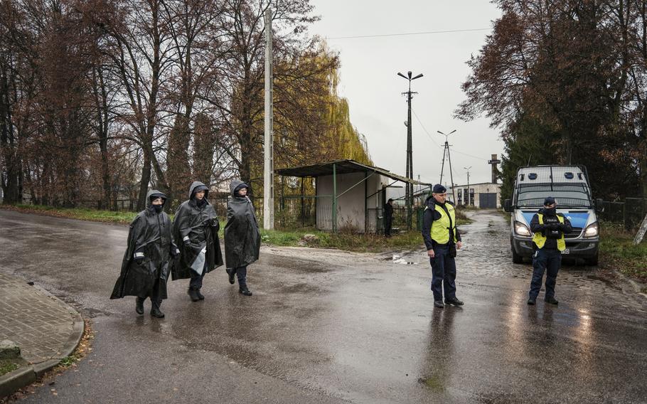 Police officers near the site where a missile killed two people on Tuesday afternoon in Przewodow, Poland.