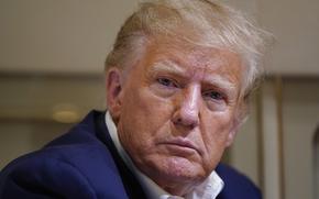 Former President Donald Trump listens as he speaks with reporters while in flight on his plane after a campaign rally at Waco Regional Airport, in Waco, Texas, March 25, 2023, while en route to West Palm Beach, Fla.
