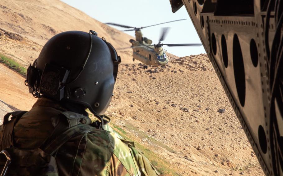 A U.S. soldier monitors flight operations over the Syrian landscape.