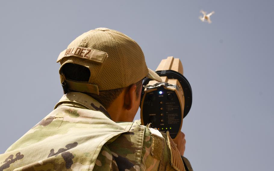 Airman 1st Class Phillip Valdez uses a specialized gun to jam a drone at Prince Sultan Air Base in Saudi Arabia on June 9, 2023.