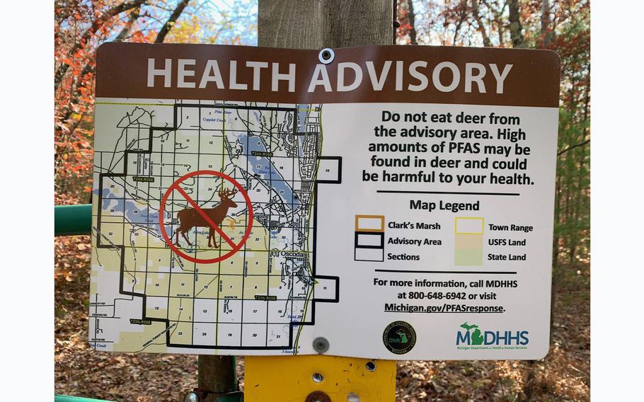 A health advisory sign posted at Clark’s Marsh, south of the former Wurtsmith Air Force Base, states that deer should not be eaten due to the potential for “high amounts of PFAS” in the meat, and shows a map of the surrounding area. 