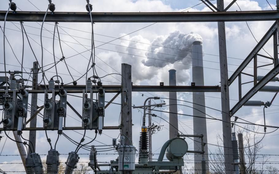 Emissions rise from a smoke stack, behind a substation at the Conesville Power Plant in Conesville, Ohio, on April 18, 2020.