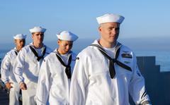 Sailors man the rails aboard the aircraft carrier USS Abraham Lincoln in San Diego, Aug. 11, 2022. 