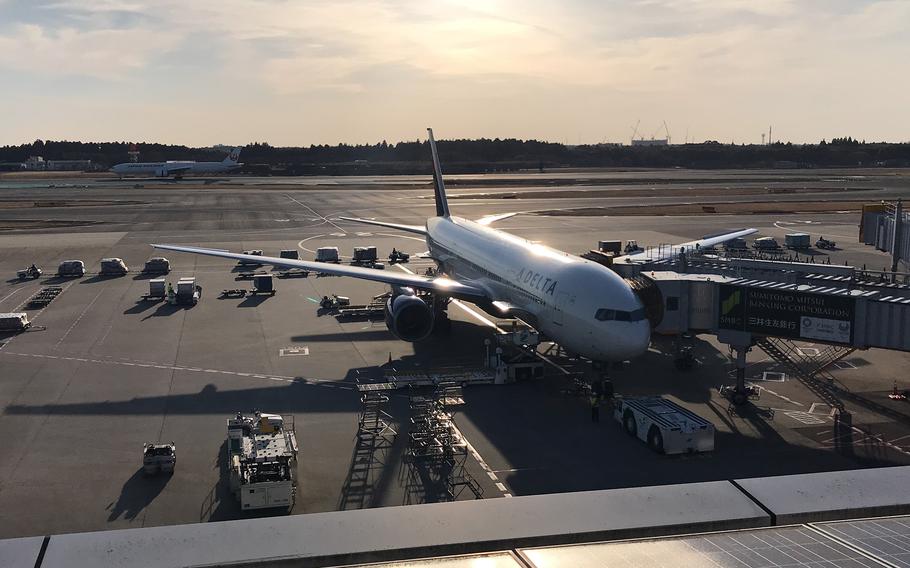 A commercial plane parks near a gate at Narita International Airport east of Tokyo on March 9, 2019. 