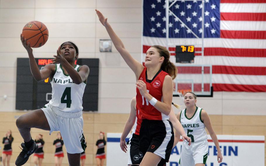 Naples’ Vanae Filer goes to the basket against AOSR’s Natalia DiMatteo in the Division II championship game at the DODEA-Europe basketball finals in Ramstein, Germany, Feb. 18, 2023. AOSR defeated Naples 26-25 to take the title.