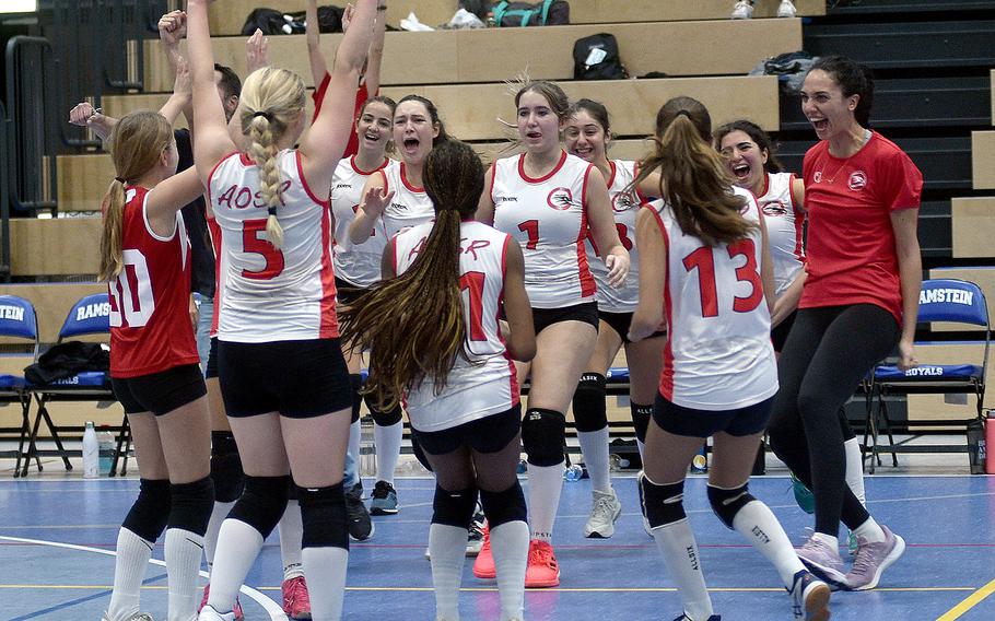 The American Overseas School of Rome celebrates after defeating Naples in a Division II semifinal during the DODEA European volleyball championships Friday at Ramstein High School on Ramstein Air Base, Germany.