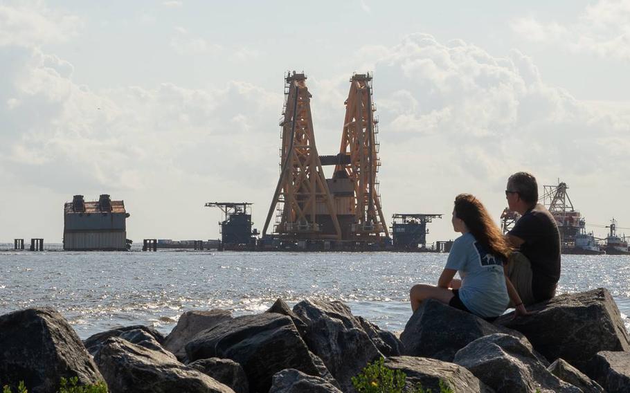 A towering crane straddles remains of the shipwrecked cargo vessel Golden Ray in the waters off St. Simons Island, Ga., on Sunday, Sept. 5, 2021. The South Korean freighter overturned on Sept. 8, 2019, shortly after leaving the Port of Brunswick.
