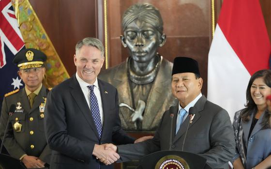 Indonesian Defense Minister Prabowo Subianto, right, shakes hands with Australian Deputy Prime Minister and Defense Minister Richard Marles following their meeting in Jakarta, Indonesia, on Feb. 23, 2024.