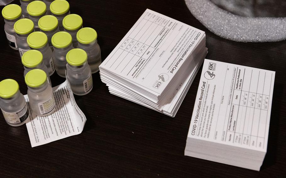 Vials of Sodium Chloride sit next to COVID-19 vaccination record cards at a nursing home in the New York borough of Brooklyn on Jan. 5, 2021. 