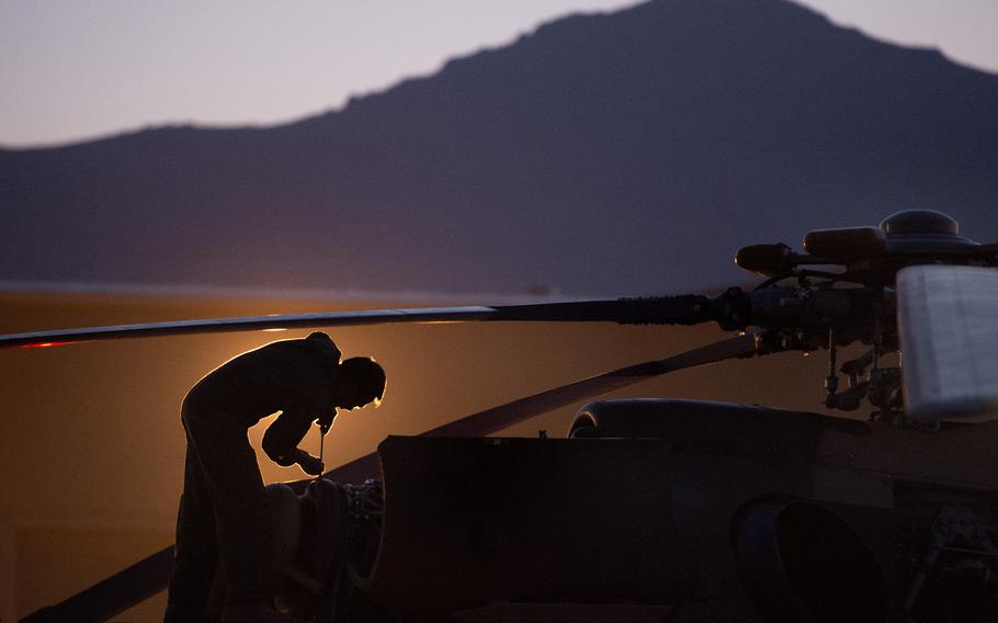 An Afghan air force technician maintains a helicopter for an early morning takeoff from Kabul International Airport, Afghanistan in 2013. Afghan maintainers said theyve been practicing remote assistance video calls for two months, in anticipation of most U.S-funded maintenance contractors departing the country soon. 