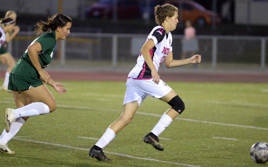 Kadena's Marina Sawyer dashes for the ball ahead of Kubasaki's Ally Garcia during Wednesday's DODEA-Okinawa girls socceer match. The Dragons won 3-1.