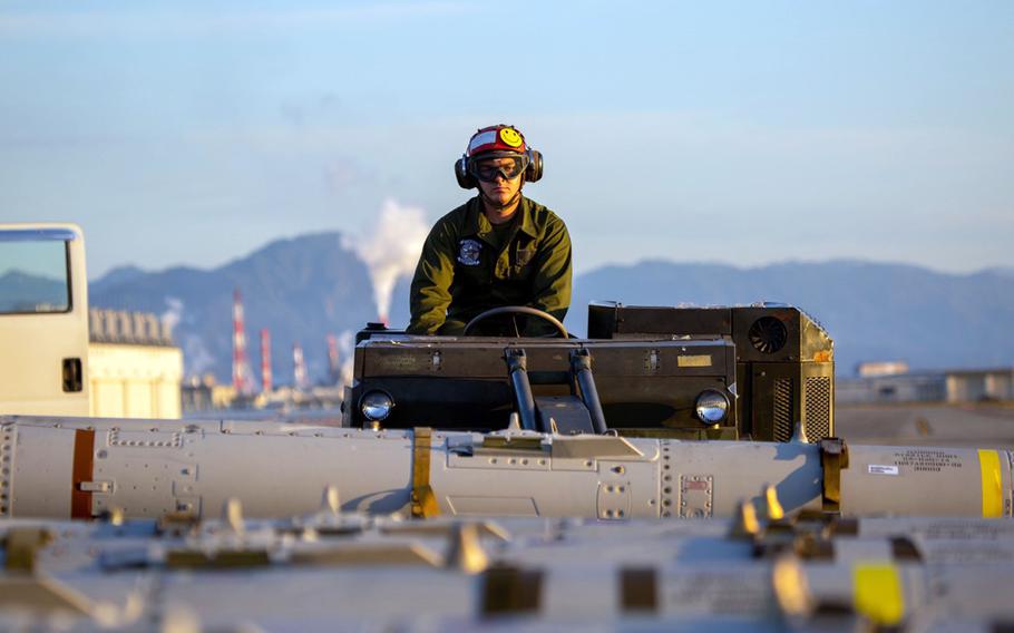 Lance Cpl. Christian Wente, an aircraft ordnance technician with Marine Fighter Attack Squadron 112, lifts an AGM-84D Harpoon missile at Marine Corps Air Station Iwakuni, Japan, Oct. 19, 2021. 