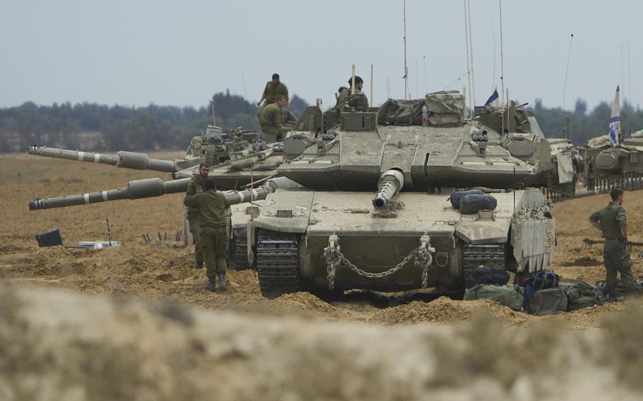 Israeli soldiers with several israeli tanks.