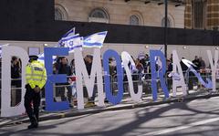 Protestors demand democracy during the visit of Israeli Prime Minister Benjamin Netanyahu to 10 Downing Street in London, Friday, March 24, 2023.(AP Photo/Alberto Pezzali)