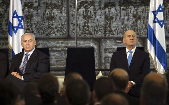 Outgoing Prime Minister Ehud Olmert, right, sits with new Israeli Prime Minister Benjamin Netanyahu during a handover ceremony at the president's residence in Jerusalem, April 1, 2009. Israel’s former prime minister on Thursday, March 16, 2023 urged world leaders to shun Israel’s current prime minister, Benjamin Netanyahu, as he presses ahead with a plan to overhaul the country's justice system. The United States and Germany, two of Israel’s closest allies, called on Netanyahu to slow down. (AP Photo/Menahem Kahana, Pool)