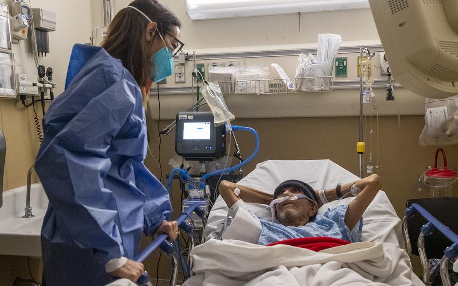 Dr. Marwa Kilani, left, the director of palliative care, talks with Jose Luis Zarate Ventrura’s hand at Providence Holy Cross Medical Center on Wednesday, Jan. 12, 2022, in Mission Hills, Calif.