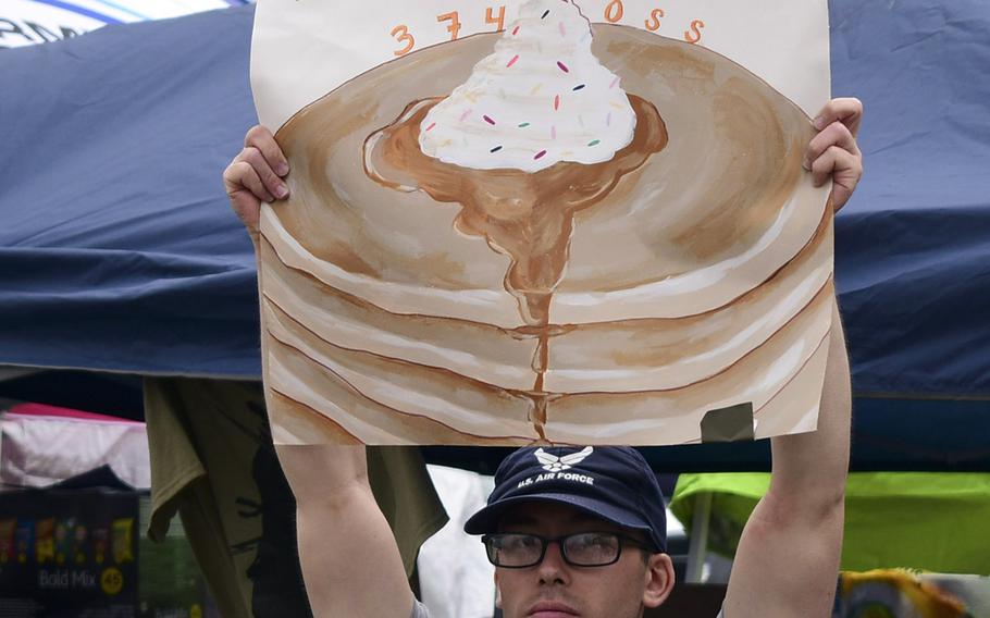 An airman advertises pancakes to Friendship Festival visitors at Yokota Air Base in western Tokyo, Saturday, May 20, 2023. 