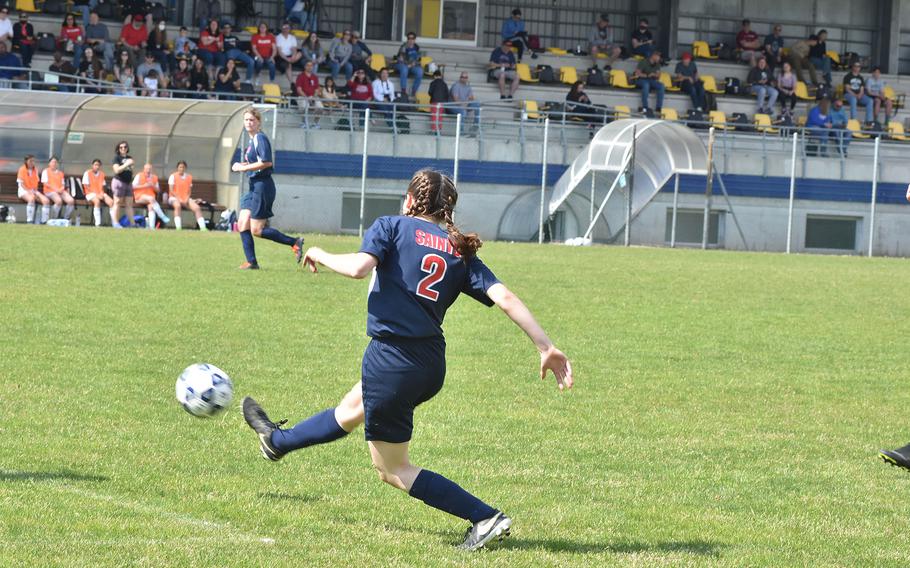 Aviano's Aila Kimball kicks the ball up the field in the Saints' 5-3 loss to the Naples Wildcats on Saturday, April 16, 2022, in Aviano, Italy.