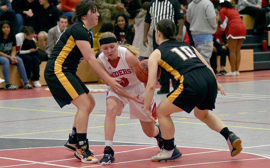 Kaiserslautern’s Lena Herrmann tries to dribble through Stuttgart’s Kinsey Heaton, left, and Bella Henderson at Kaiserslautern High School on Friday in Kaiserslautern, Germany.