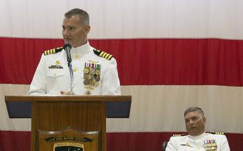 Capt. Odin Klug delivers remarks as he assumes command of U.S. Naval Support Activity Souda Bay, Greece, from Capt. Rafael C. Facundo, right, on July 29, 2022.