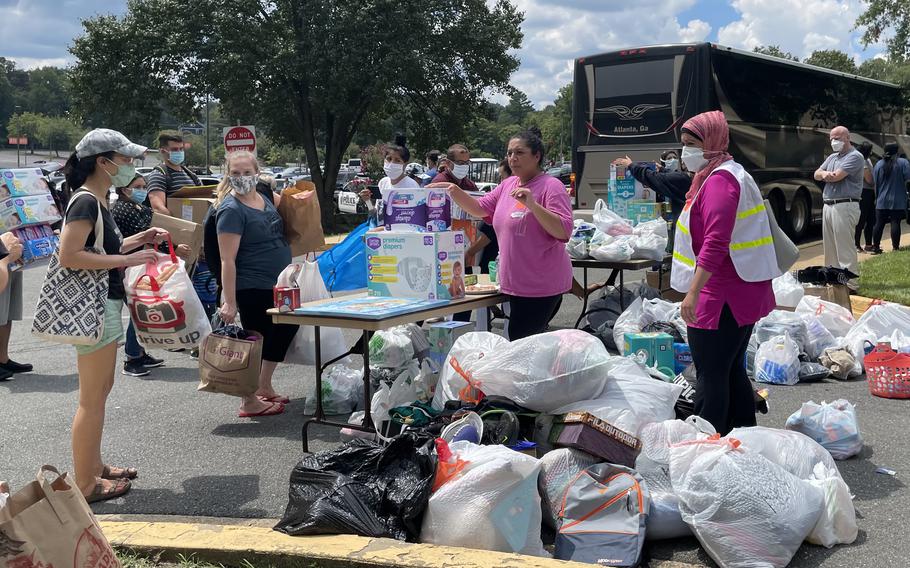 People drop off donations at Northern Virginia Community College on Aug. 21, 2021, in Annandale, Va., to aid the hundreds of Afghan refugees or special-immigrant visa recipients who arrived overnight after a harrowing journey from Kabul. 