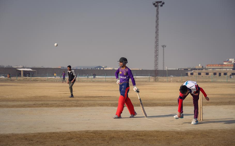 Players take part in a weekly friendly match between local rival teams in Kabul on a private cricket field. 