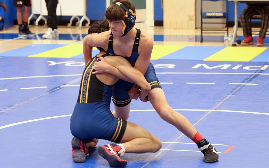 Yokota's Ethan Romney takes control of the 107-pound final against teammate Jay Gutierrez during Saturday's Yokota wrestling tournament.