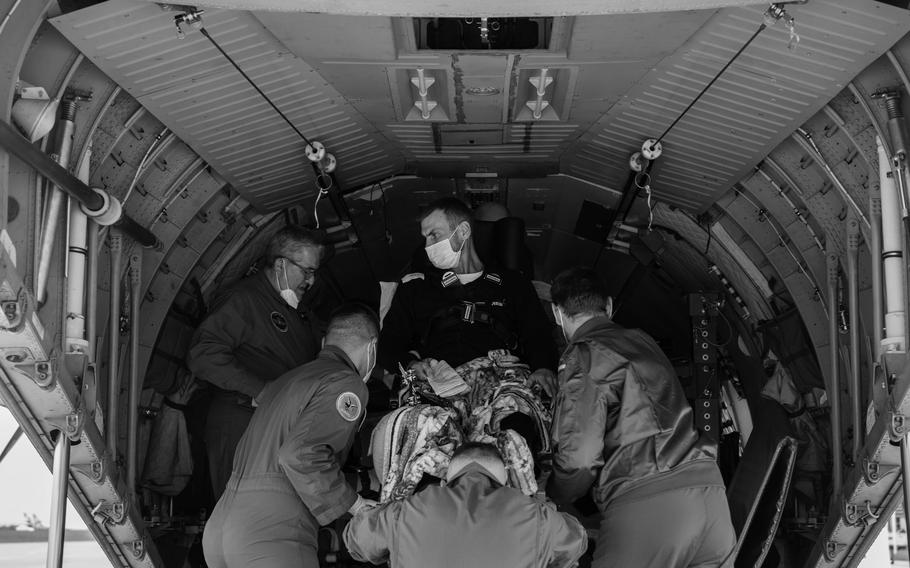 A patient with leg injuries is loaded into a Spanish military plane at the airport in Rzeszow, Poland, to be transported to Zaragoza, Spain, for treatment. Several western European nations rely on paramedic teams like this one to enter Ukraine and evacuate the patients. 