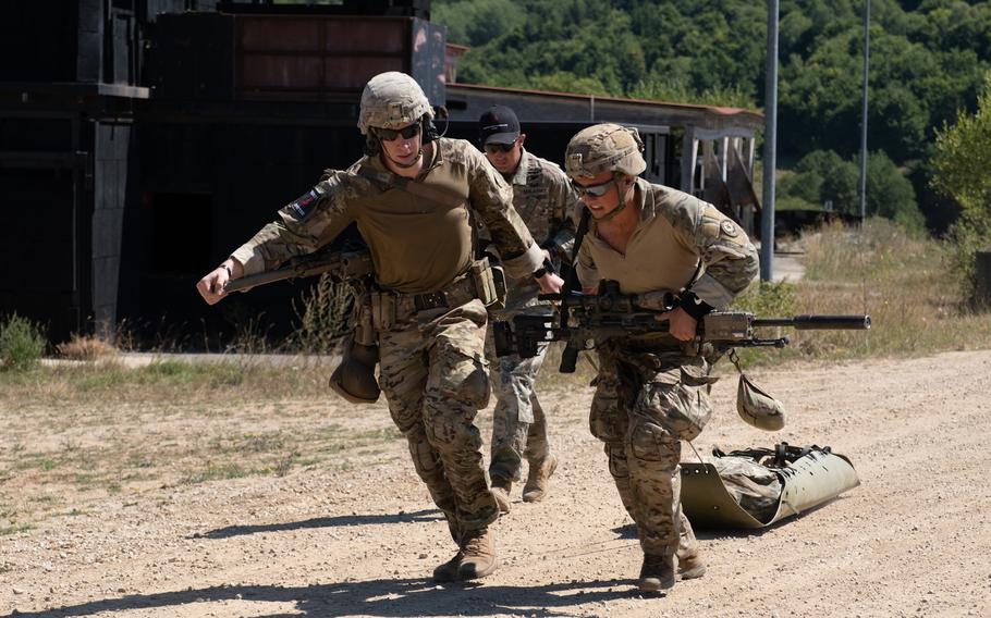 U.S. soldiers evacuate a pilot with simulated injuries as part of an event in the European Best Sniper Competition at Hohenfels Training Area in Germany on Aug. 8, 2022.