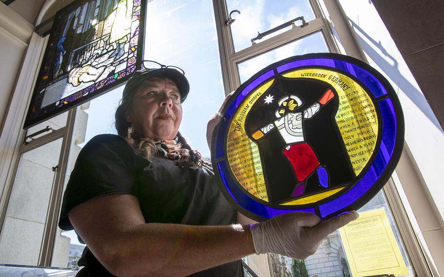 Stained glass artist Armelle Le Roux installs “Remembered Light,” a stained glass art exhibit made from the window shards of churches bombed in World War II collected by Fred McDonald, then a chaplain in the U.S. Army. 