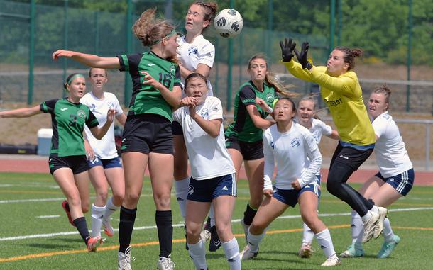 The ball flies past friend and foe in front of the Black Forest Academy goal during Division II final action at the DODEA-Europe soccer championships in Ramstein, Germany, May 22, 2025. Naples beat BFA 3-0 to take the division title.