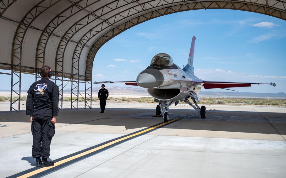 U.S. Air Force Senior Airman Carter Pals, left, Senior Airman Elias Sanchez, center, and Capt. Taylor “FEMA” Hiester, F-16 Viper Demonstration Team commander and pilot, right, conduct pre-flight checks at Edwards Air Force Base, Calif., May 13, 2024.