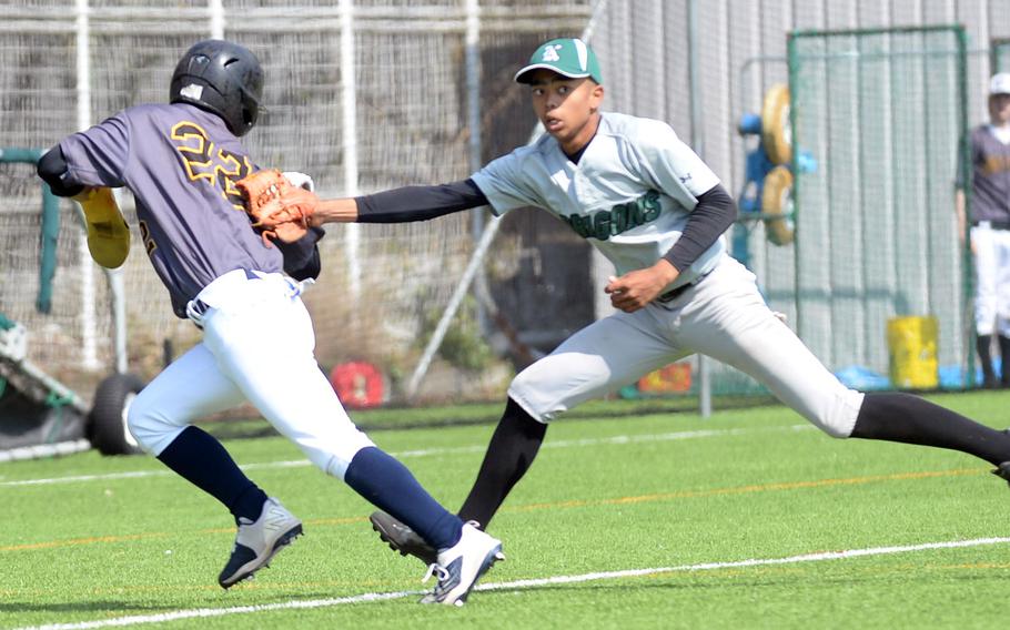 American School In Japan's Toshi Odaira gets tagged out in a rundown by Kubasaki shortstop Luka Koja.