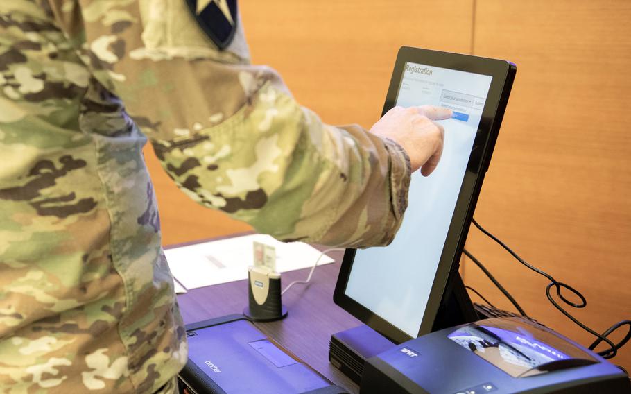 A service member tests an early-stage prototype of voting technology aimed at improving the experience of military absentee voters at the Defense Advanced Research Project Agency in Arlington, Va., Feb. 7, 2024. 