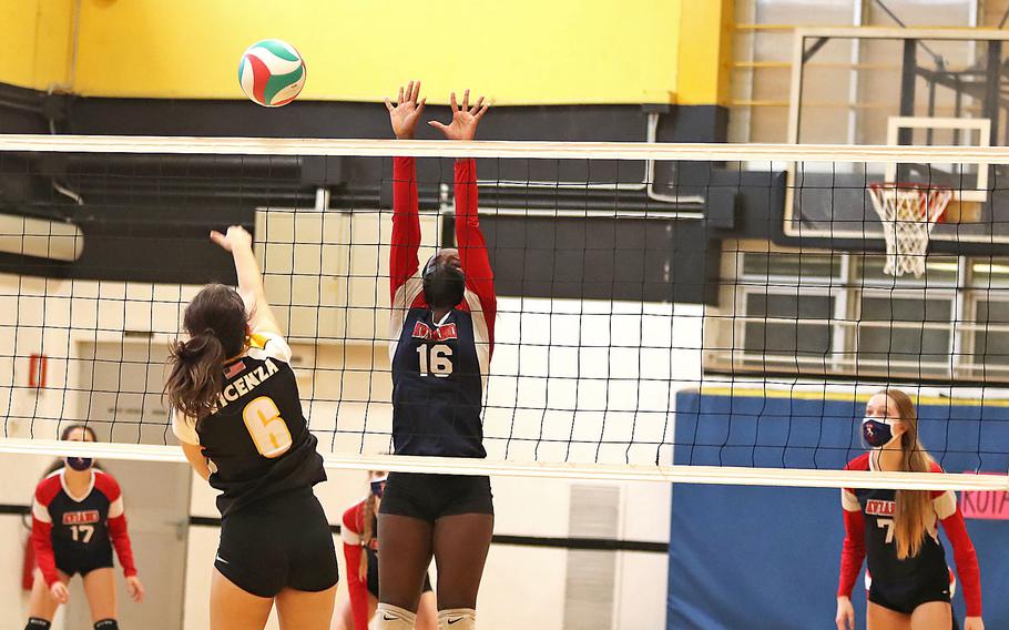 Julia Ridgley of the Vicenza Cougars goes up for a kill as Aviano’s Zurnia Dickerson tries to block during the DODEA-Europe Division II tournament in Vicenza, Italy on Saturday, Oct. 30, 2021.  Vicenza won 25-19, 25-23, 20-25, 26-24.