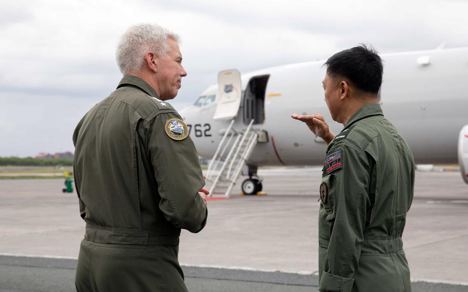 Vice Adm. Karl Thomas, left, commander of the U.S. 7th Fleet, speaks with Philippine navy commodore Juario Marayag before boarding a Navy P-8A Poseidon in Manila, Philippines, Aug. 26, 2023.